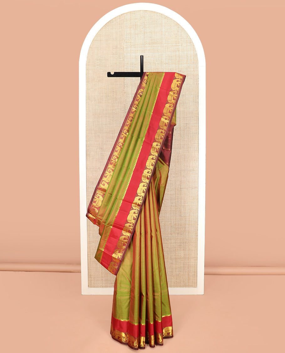 Green Dual-Toned Vazhaipoo Striped Kanchipuram Silk Saree, Complemented By Contrast Rettai Pettu Border Of Thilakam Mokku, And Yaanai Designs, Pallu Subtly Woven In Stripes, And Paired With A Contrast Blouse