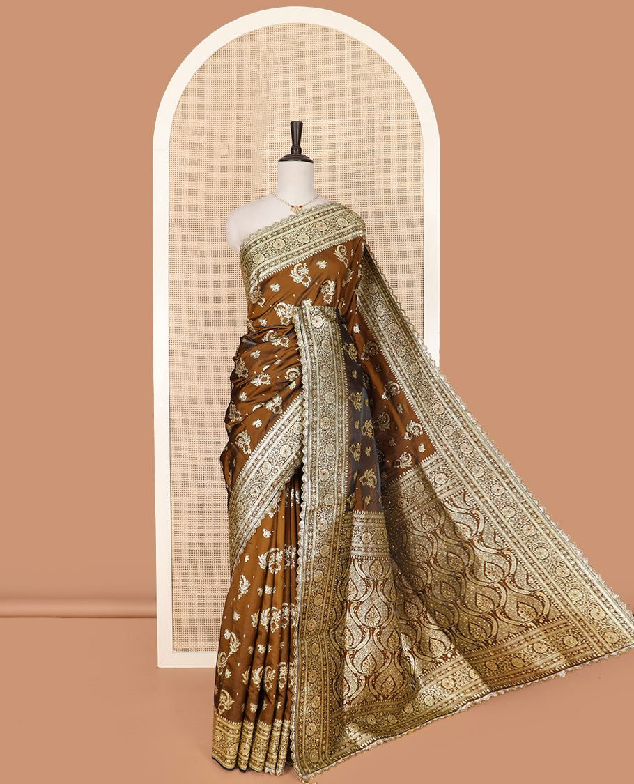 Brown Art Vastrakala Silk Saree Graced With Zari Buttas With Stone Work All Over Its Body, Complemented By A Floral Creeper Zari Stone Work Lace Border, Mughal-Style Pallu Detailed In Zari And Stone Work, And Paired With A Matching Blouse