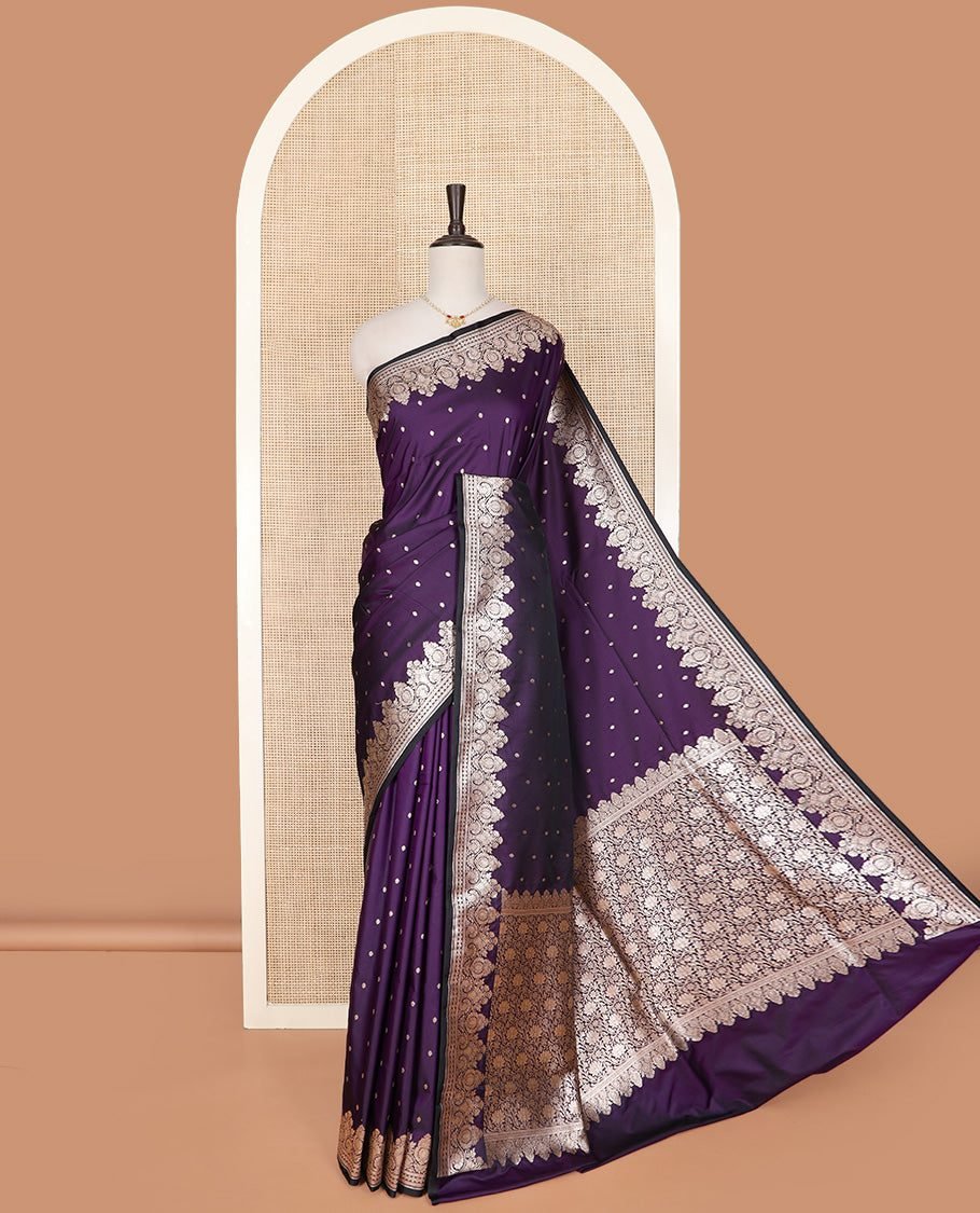 Violet Semi-Banaras Satin Saree Subtly Sparkled With Zari Buttas, Self-Border Gleamed Up With Intricate Designs, Pallu Artfully Detailed With Floral Jaal Designs, And Paired With A Matching Blouse