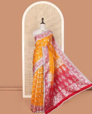 Orange Semi-Banaras Nylon Saree Highlighted With Floral Jaal Jacquard And Stone Work, Complemented By A Contrast Floral Creeper Zari Stone Work Lace Border, Floral Bouquets Themed Pallu Detailed In Zari And Stone Work, And Paired With A Contrast Blouse