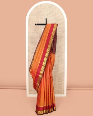 Orange Vazhaipoo Striped Kanchipuram Silk Saree, Complemented By Contrast Rettai Pettu Border Of Thilakam Mokku, And Yaanai Designs, Pallu Subtly Woven In Stripes, And Paired With A Contrast Blouse