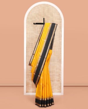 Yellow Mayuri Soft Silk Saree, Subtly Sparkled With Zari Buttas All Over Its Body, Complemented By A Contrast Border Of Rekku, Paisa, Manga, And Thazampoo Rekku Designs, Intricately Designed Pallu, And Paired With A Contrast Blouse