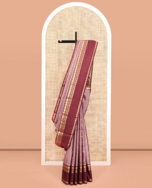 Grey Vasundhara Silk Saree, Adorned With Zari Buttas All Over Its Body, Complemented By A Contrast Rettai Pettu Border Of Yaanai Designs, Grand Jaal Pallu, And Paired With A Contrast Blouse