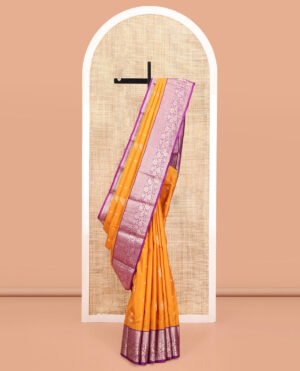 Yellow Vasundhara Silk Saree, Subtly Enriched With Zari Buttas All Over Its Body, Complemented By Contrast Border Of Neli, Muthu, Poun, And Kodi Visiry Designs, Grand Pallu, And Paired With A Contrast Blouse