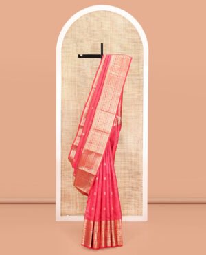 Red Vasundhara Silk Saree, Enriched With Zari Buttas And Checks All Over Its Body, Highlighted By Zari Border Of Rekku, Mayil Kann, Vanki, Then Kuli Kann, And Round Mayil Designs, Grand Pallu Of Butta Enclosed Checks, And Paired With A Matching Blouse