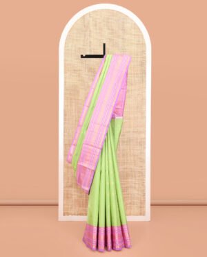 Green Vasundhara Silk Saree, Accentuated With Mayil And Chakram Buttas All Over Its Body, Complemented By A Contrast Border Of Rekku, Muthu, Kathir, Poun, Mayil And Mayil Kann Designs, Grand Pallu, And Paired With A Contrast Blouse