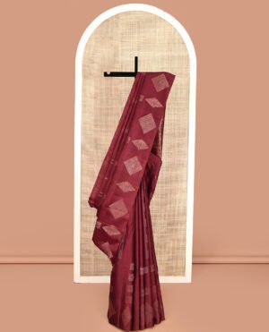 Borderless Maroon Mayuri Soft Silk Saree, Adorned With Buttas All Over Its Body, A Self-Pallu Of Geometric Patterns, And Paired With A Matching Blouse