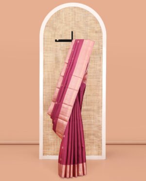 Light Maroon Vasundhara Silk Saree, Woven With Zari Buttas All Over Its Body, Complemented By A Contrast Border Of Rekku, Muthu, Kili, Banaras, Neli, And Mayil Kann Designs, Grand Pallu, And Paired With A Contrast Blouse