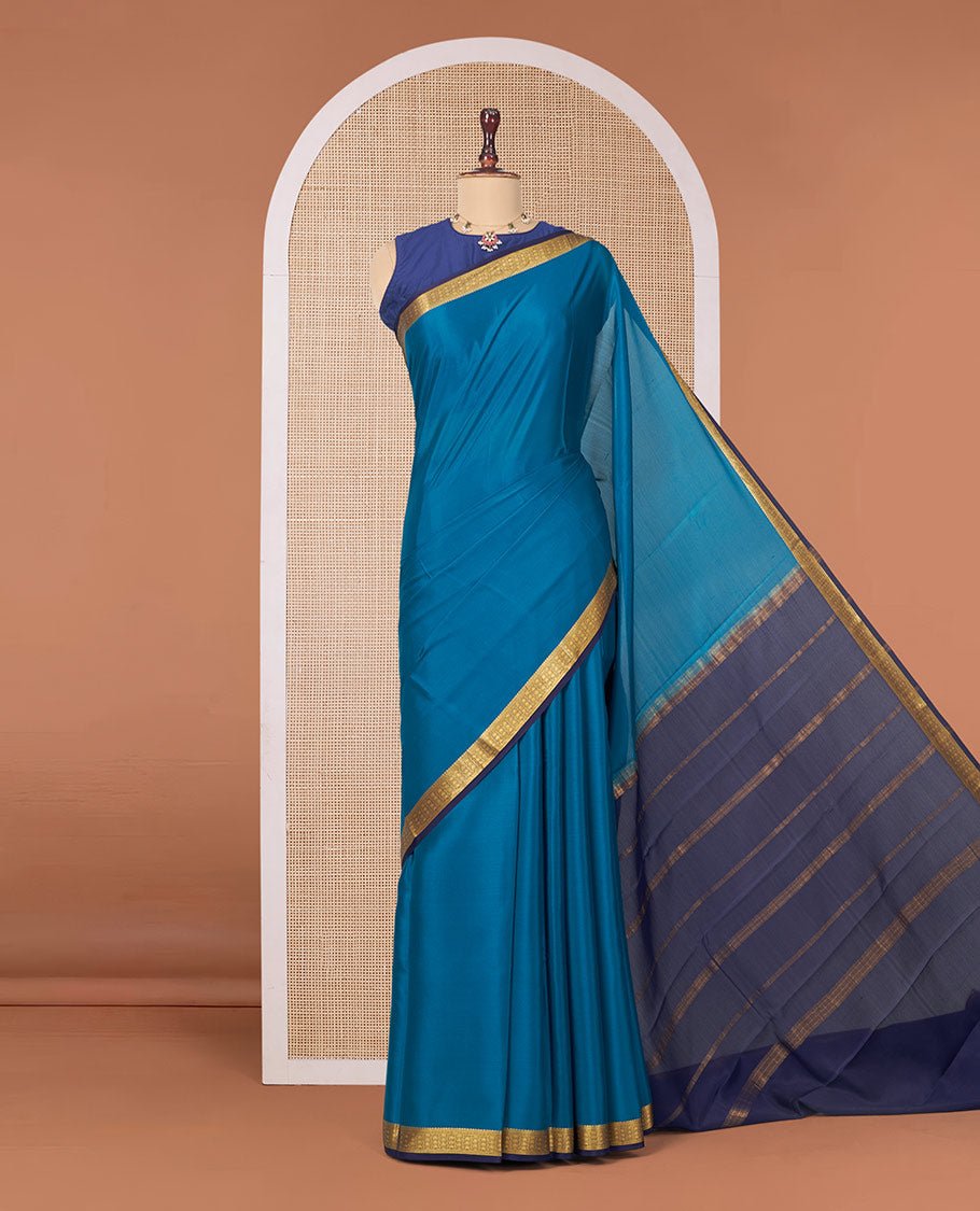 Peacock Blue Plain Mysore Silk Saree, Complemented By A Contrast Traditional Zari Design Border, Zari Striped Pallu, And Paired With A Contrast Blouse
