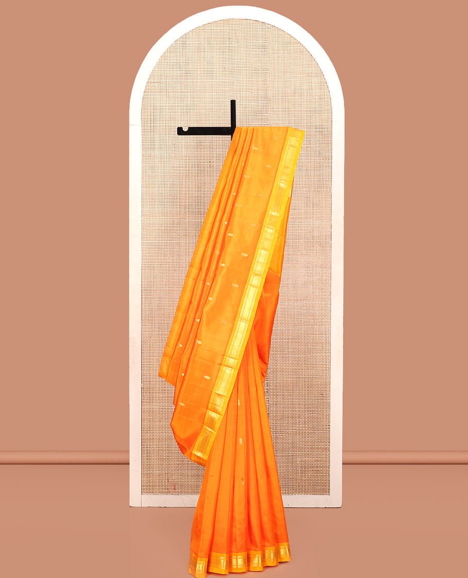 Orange Kanchipuram Silk Saree, Adorned With Zari Buttas, A Contrast One-Sided Border Of Banaras, And Jaal Design, Zari-Woven Pallu, And No Blouse