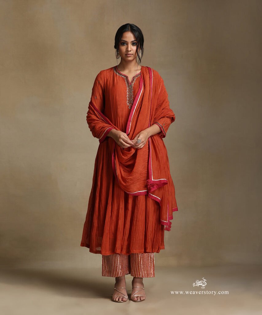 Burnt Orange Hand Embroidered Pure Chanderi Notched Neck Anarkali Kurta With Pants And Dupatta by WeaverStory, South Asian ethnic wear