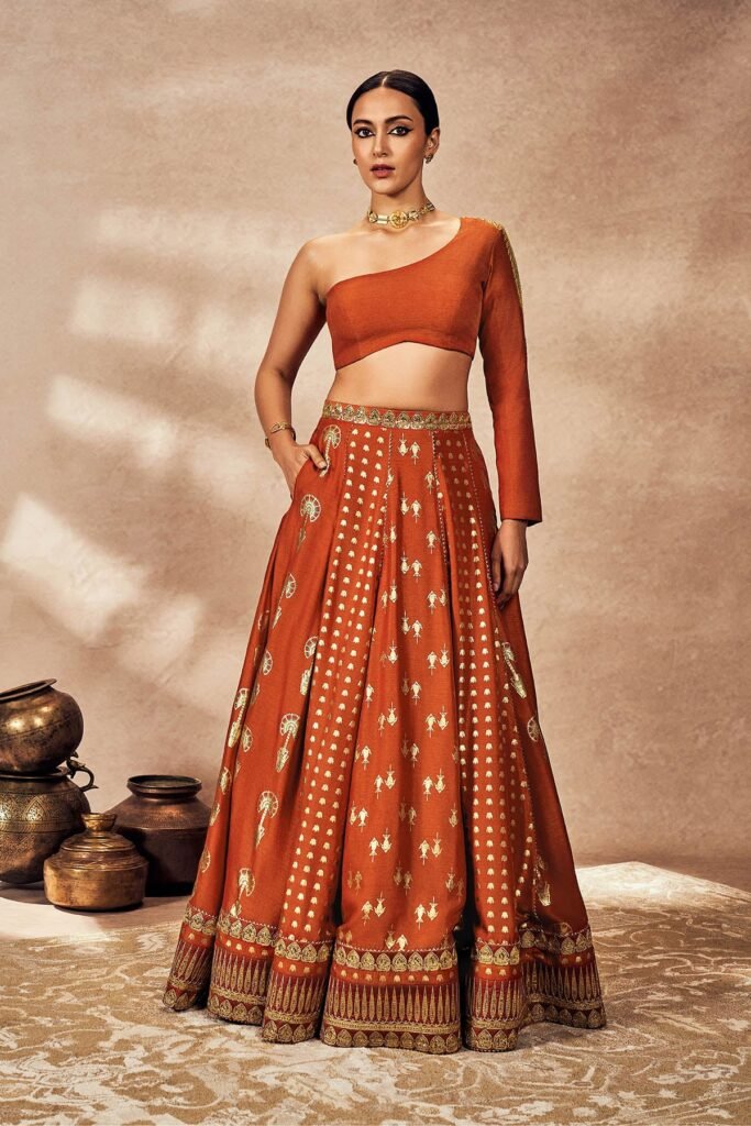 Rust Foil One Shoulder Lehenga Set by Masaba, South Asian ethnic wear